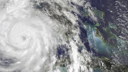 Satellite image of Category 4 Hurricane Helene making landfall in Florida, USA, with powerful winds and heavy rainfall causing widespread damage.