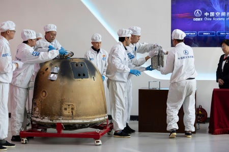 Researchers prepare to weigh Chang'e-6 lunar samples.