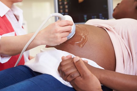 Pregnant Woman And Partner Having 4D Ultrasound Scan