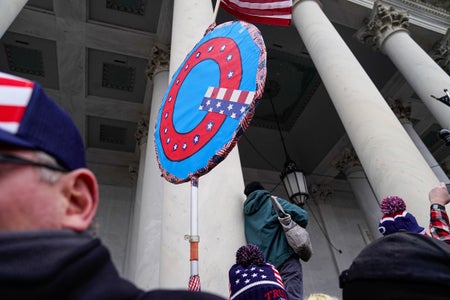 Qanon sign held outside US Capitol building.