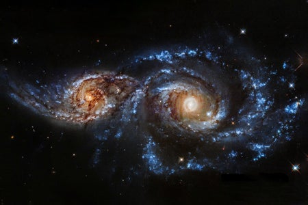 Two colliding spiral galaxies are on the cusp of merging into an intermingled swirl of stars.