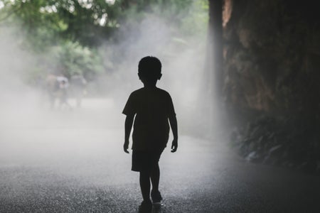 Silhouette of a boy in the fog