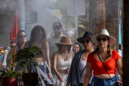 People walking under water misters