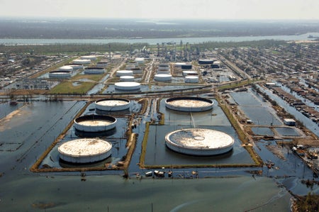 Flooded storage tanks are pictured on the grounds of a refinery