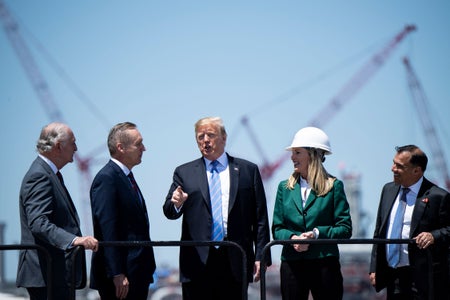 Then President Trump speaking outdoors surrounded by a team.